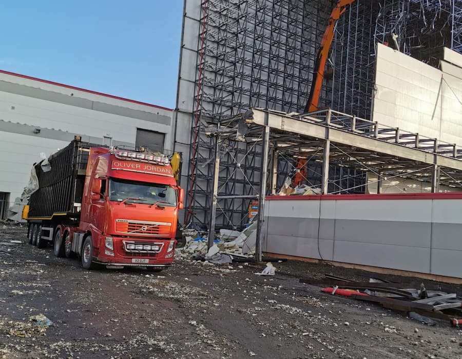 Red oliver jordan truck at demolition site